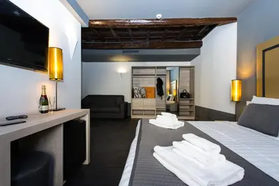 a hotel room with a bed with towels on it at Relais Santa Maria Maggiore in Rome