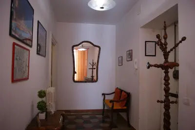a hallway with a mirror and a chair at Tatusa al Colosseo in Rome