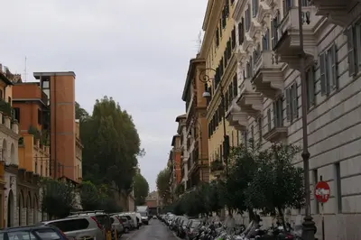 a street with cars parked on the side of a building at Tatusa al Colosseo in Rome