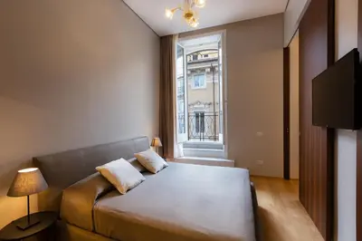 a living room with a couch and a window at Amazing Piazza Venezia Suites in Rome