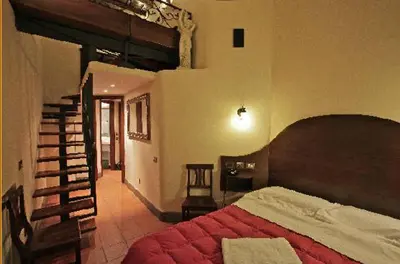 a bedroom with a large bed and a staircase at Hotel Panda in Rome