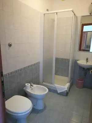 a bathroom with a toilet and a shower and a sink at Palma Residences In Rome in Rome