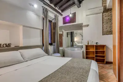 a bedroom with a bed and a bathroom with a tub at Easybnb - Luxury Navona in Rome