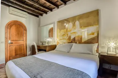 a bedroom with a large bed and a desk at Easybnb - Luxury Navona in Rome