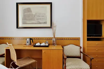 a hotel room with a desk and two chairs at Sonnino Suite in Rome