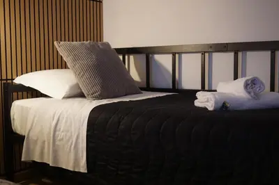 a bed with pillows and towels on top of it at VMH Vatican Modern House in Rome