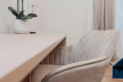 a chair next to a table with a potted plant at Cesare ai Cavalieri Suites in Rome