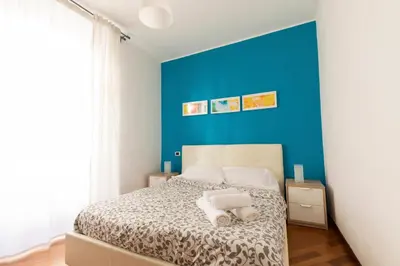a bedroom with a blue wall and a bed at Borgo Vittorio St. Peter Apartments in Rome