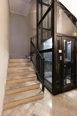 a staircase with wooden steps and a black door at Harry's Bar Trevi Luxury Apartments - Modelli in Rome