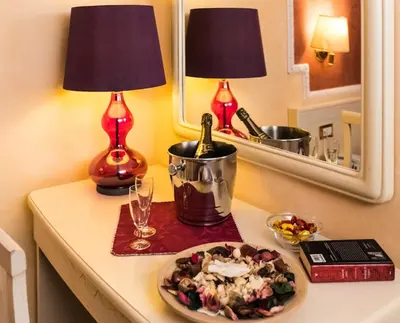 a table with a plate of food and a bottle of wine at Hotel Erdarelli in Rome