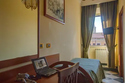 a room with a desk with a laptop computer on it at Hotel Giorgina in Rome