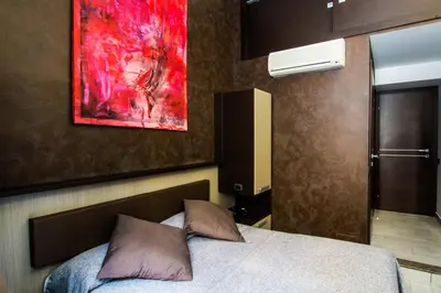 a bedroom with a bed and a painting on the wall at Hotel Charter in Rome
