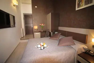a bedroom with a bed with two teddy bears on it at Hotel Charter in Rome