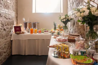a long table with food and drinks on it at Hotel Metropolis in Rome