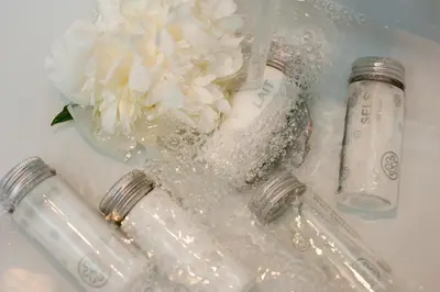 a white flower in a glass vase in a sink at Hotel Metropolis in Rome