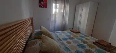 a bedroom with a bed with a comforter on it at Trastevere St. Garden House in Rome