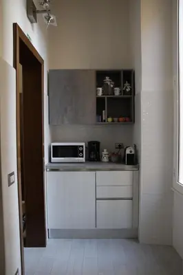 a kitchen with a counter top with a microwave at rHome Sweet Home - Trastevere in Rome