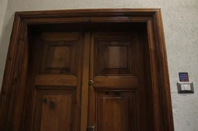 a wooden door with two windows on a wall at rHome Sweet Home - Trastevere in Rome