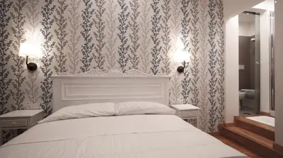 a bedroom with a white bed with floral wallpaper at Domus Iuliae in Rome