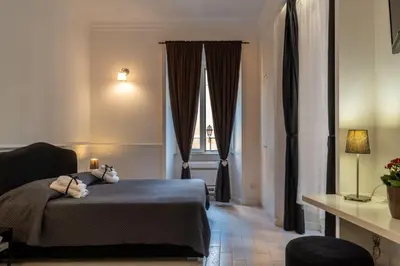 a bedroom with a bed with a teddy bear on it at Intra' Residenza in Trastevere in Rome