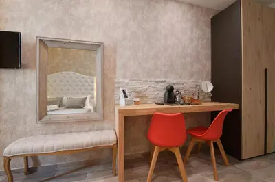 a room with a vanity with a mirror and two chairs at Relais Barberini in Rome