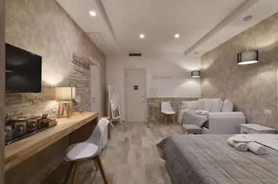 a bedroom with a bed and a living room at Relais Barberini in Rome