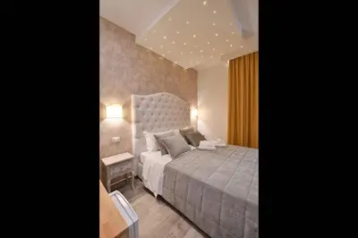 a bedroom with a large bed and a table at Relais Barberini in Rome