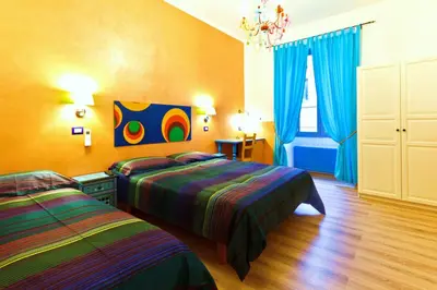 a bedroom with two beds and a chandelier at Dream Station in Rome
