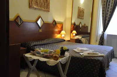 a hotel room with a bed with a tray of food on it at Hotel Farini in Rome