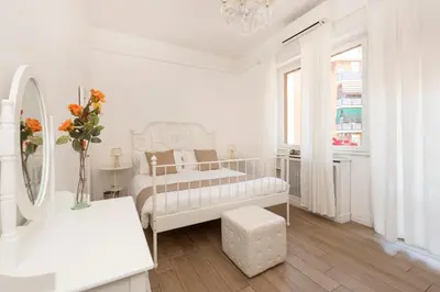 a white bedroom with a bed and a mirror at Roma Chic Flat Monte Mario in Rome