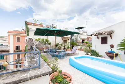 a backyard with a swimming pool and an umbrella at Hotel Celio in Rome