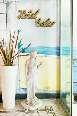 a statue of a woman standing in front of a sign at Hotel Celio in Rome
