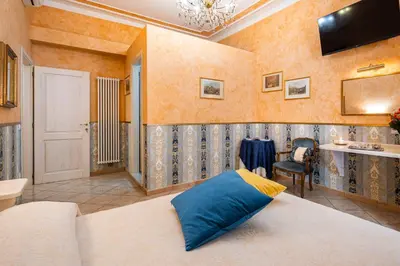 a bedroom with a bed with a blue pillow on it at Affittacamere Guest House Glatimia in Rome