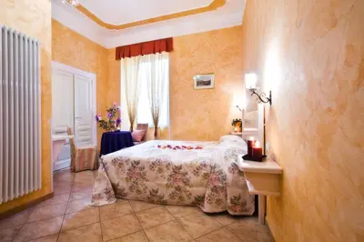 a bedroom with a bed and a table and a window at Affittacamere Guest House Glatimia in Rome