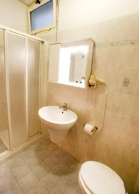 a bathroom with a toilet and a sink at Hotel Adriatic in Rome