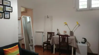 a dining room with a table and chairs and a window at Dreaming Navona Rooms in Rome