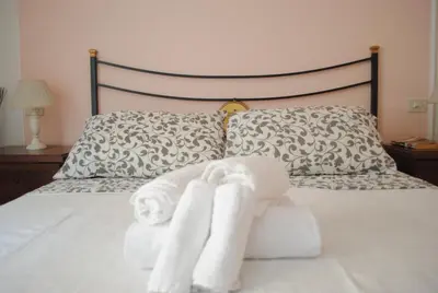 a bedroom with a bed with towels on it at Dreaming Navona Rooms in Rome