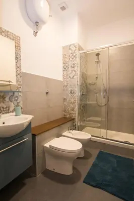 a bathroom with a toilet and a sink and a shower at Seven Rooms Vatican in Rome