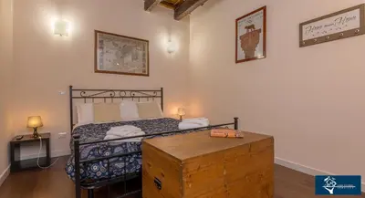 a bedroom with a bed with a wooden chest at L'Olimpo di Estia in Rome