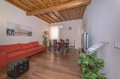 a living room with a red couch and a table at L'Olimpo di Estia in Rome