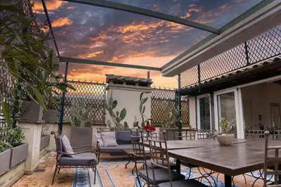 a patio with a wooden table and chairs at Orsoline Boutique Apartments - Best position in Rome in Rome