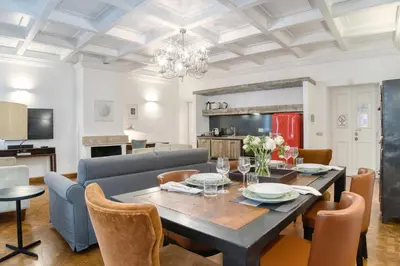 a dining room and living room with a table and chairs at Orsoline Boutique Apartments - Best position in Rome in Rome