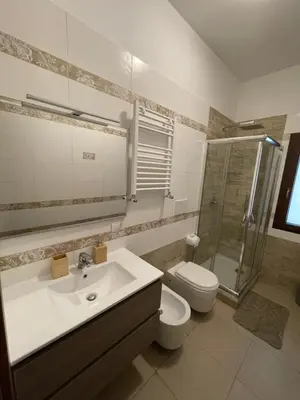 a bathroom with a sink and a toilet and a shower at Casa Rosa in Rome