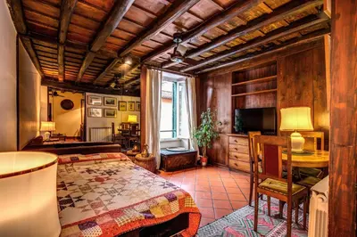 a bedroom with a bed and a desk and a television at Magenta Collection Egidio in Rome