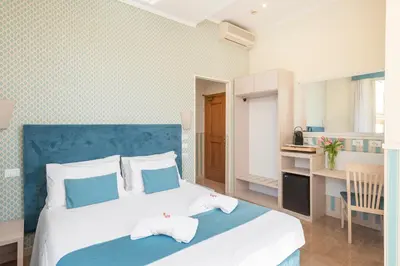 a bedroom with a large bed with a blue headboard at Hotel Parker - Gruppo BLAM HOTELS in Rome