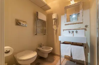 a bathroom with a toilet and a sink at Nina Casetta De Trastevere in Rome