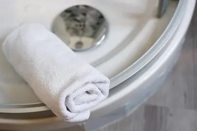 a roll of toilet paper on the side of a toilet at Crossroad Hotel in Rome