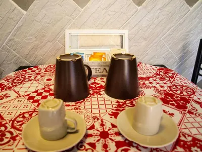 a table with three cups and saucers on it at Casa Tua a Piazza del Popolo in Rome