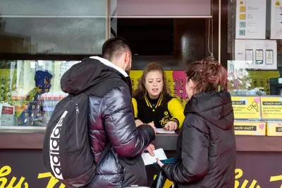 a group of people standing at a food counter at hu Roma Camping In Town in Rome