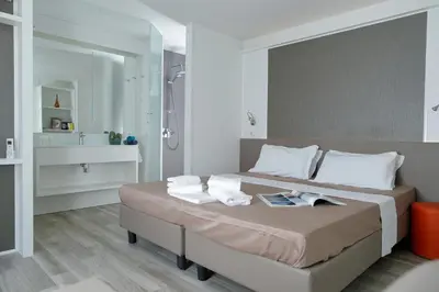 a bedroom with a large bed with towels on it at hu Roma Camping In Town in Rome